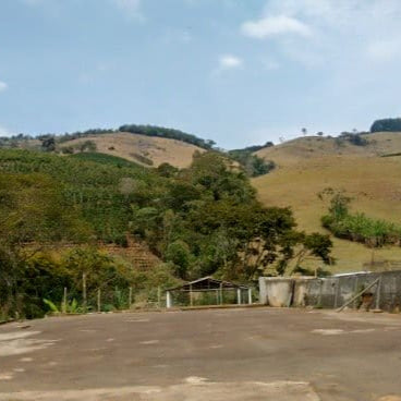 Hilly landscape with greenery and a clear blue sky