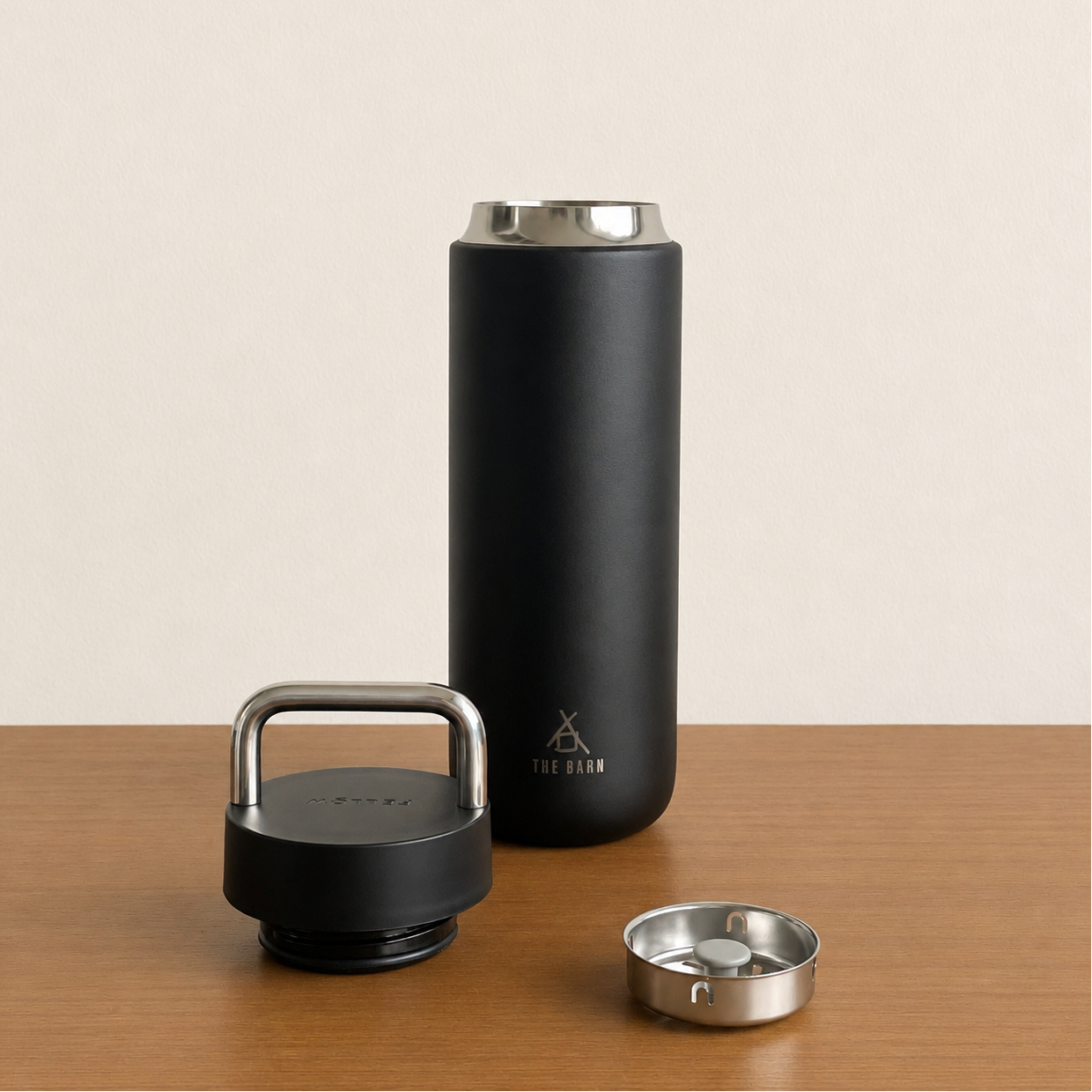 FELLOW CARTER CARRY TUMBLER in matte black with a handle and lid, showcasing its sleek design and insulation features.