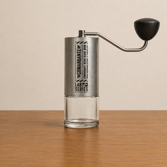 COMANDANTE C40 LAB SERIES coffee grinder with Nitro Rex stainless steel burrs on a wooden table